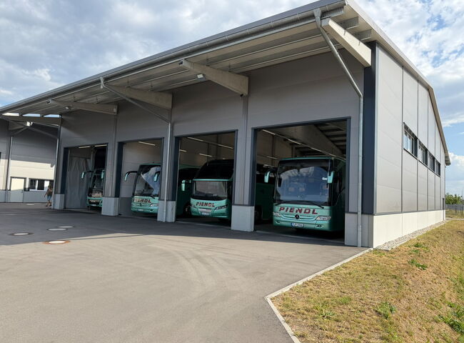 Busse stehen in einer fertiggestellten Halle